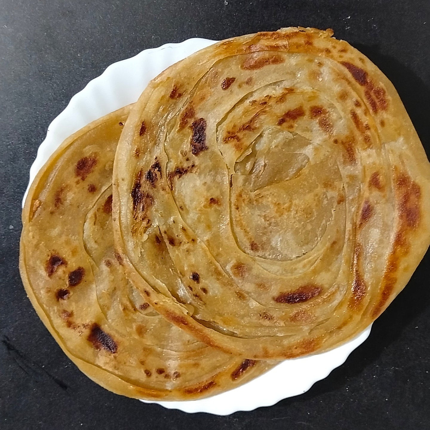 Frozen Whole Wheat Chakki Paratha by chicnbe – Healthy, traditional Indian flatbread made with chakki atta, layered and ready to cook, served hot and crispy.